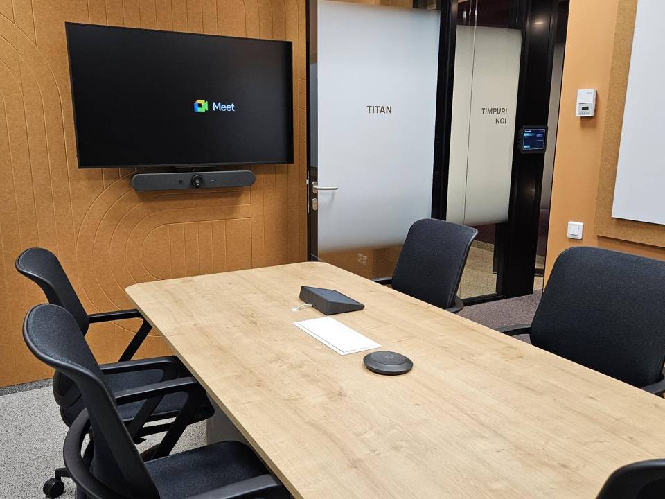 Conference room with wall display, video bar and table touch controller