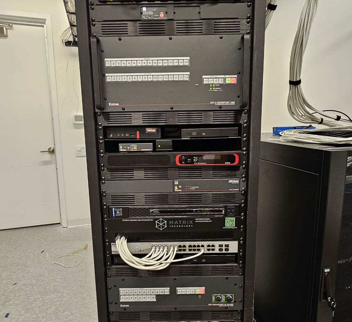 Dressed and labeled equipment rack with patch panels and switching