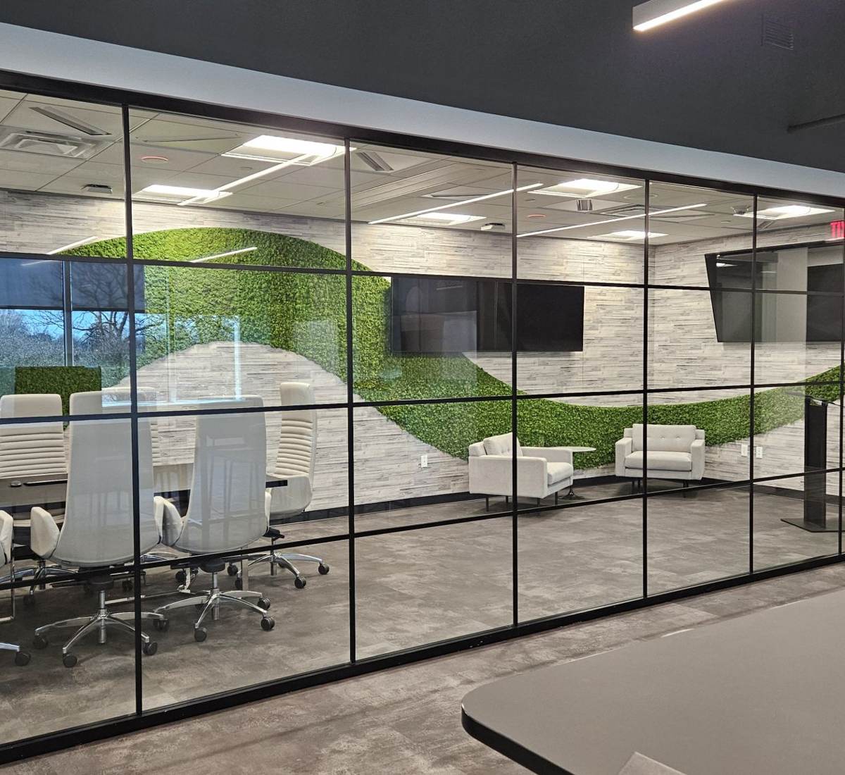Glass-walled executive suite with displays in each room
